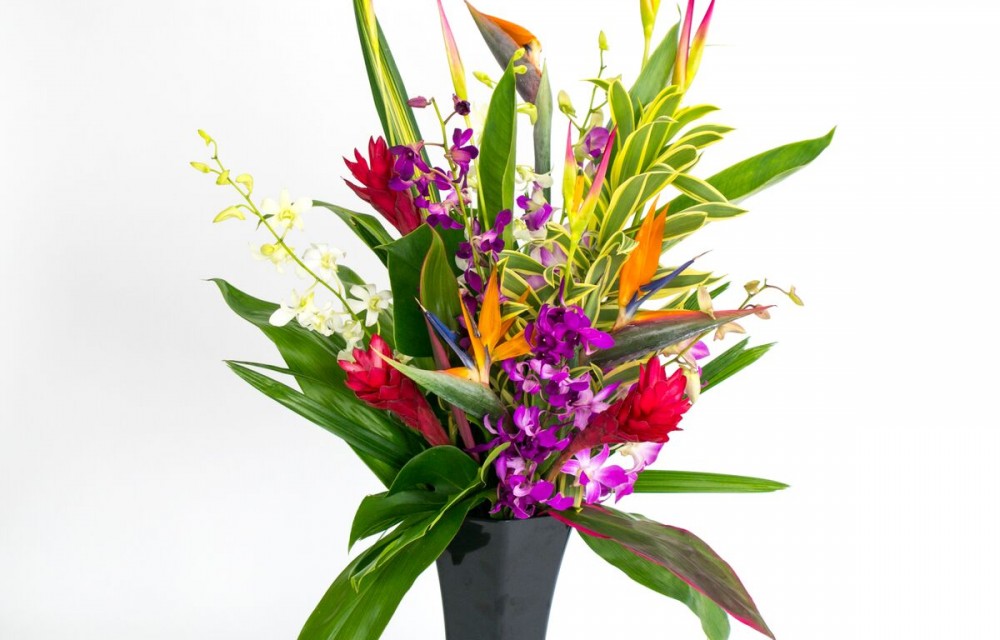 hawaiian flowers in black vase